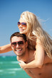 Photo: happy couple in sunglasses on the beach happy couple in sunglasses on the beach