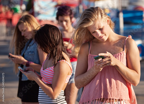 Photo: Serious Teenagers on Smartphones Serious Teenagers on Smartphones