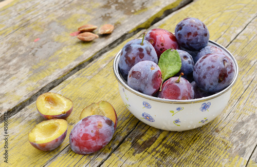 Photo: Plums on shabby wooden table Plums on shabby wooden table