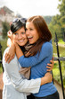 Photo: Mother kissing her daughter happy embrace outdoors Mother kissing her daughter happy embrace outdoors