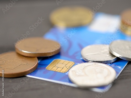 Photo: Macro shot of old blue credit card with Czech coins (crown). Macro shot of old blue credit card with Czech coins (crown).