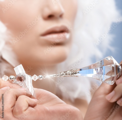 Photo: Closeup photo of crystal gem held by woman Closeup photo of crystal gem held by woman