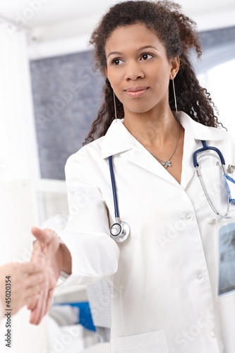 Photo: Young female doctor shaking hands Young female doctor shaking hands