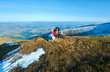 Family walk on autumn  mountain plateau with first winter snow