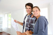 New property owners looking at home blueprint