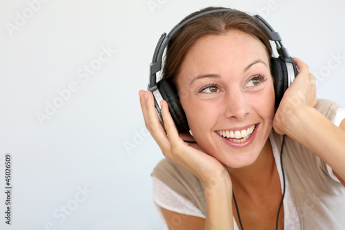 Photo: Cheerful woman with headphones, isolated Cheerful woman with headphones, isolated