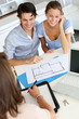 Couple meeting architect for plans of future home
