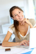 Portrait of smiling woman working on laptop at home