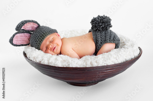 Photo: smiling newborn baby boy wearing a gray bunny rabbit costume smiling newborn baby boy wearing a gray bunny rabbit costume