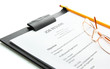 resume with pencil and glasses on clipboard, isolated on white