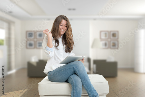 Photo: Woman at home with digital tablet Woman at home with digital tablet