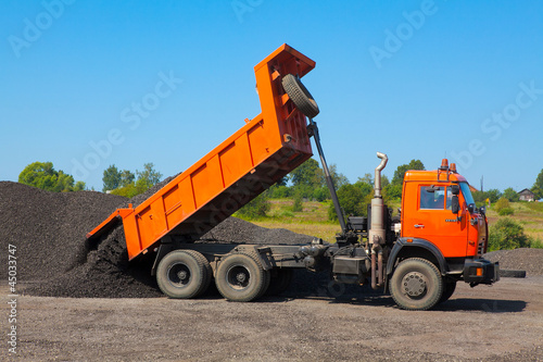 Photo: Truck is unloaded at a construction site Truck is unloaded at a construction site