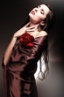 woman in chocolate drapery with red rose