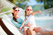 Mother and daughter relaxing in hammock