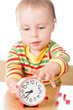 Little cute baby with clock