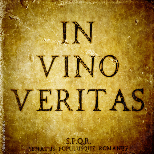 Photo: In vino veritas sign on a stone textured bacground In vino veritas sign on a stone textured bacground