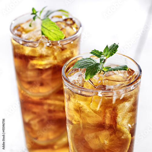 Photo: cold iced tea with mint garnish and sliced lemons cold iced tea with mint garnish and sliced lemons