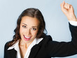 Happy gesturing business woman, over blue