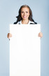 Businesswoman showing signboard, over blue