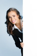 Businesswoman showing signboard, over blue