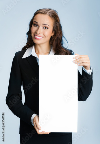 Photo: Businesswoman showing signboard, over blue Businesswoman showing signboard, over blue