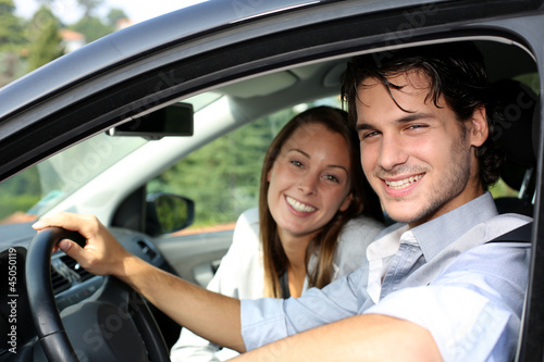 Photo: Cheerful couple driving car Cheerful couple driving car