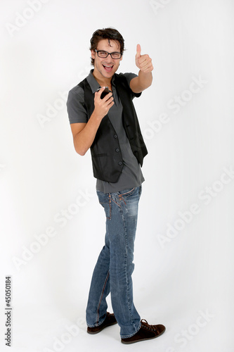Photo: Cool guy with smartphone showing thumb up Cool guy with smartphone showing thumb up
