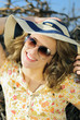 beautiful girl in shorts and hat on grapevine