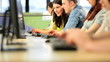 Teacher helping diverse students degree study in library