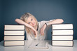 Photo: Young girl studying against dark background. Young girl studying against dark background.