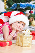 Photo: girl with gifts near a New Year tree girl with gifts near a New Year tree