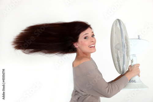 Photo: Woman with an electric fan Woman with an electric fan