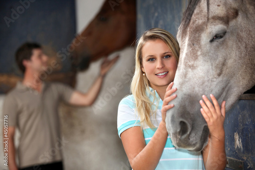 Photo: Young woman stroking her horse Young woman stroking her horse