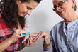 Elderly woman having her nails filed