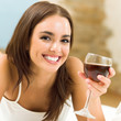 Young woman with glass of redwine