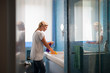 Young woman doing chores and cleaning bathroom at home