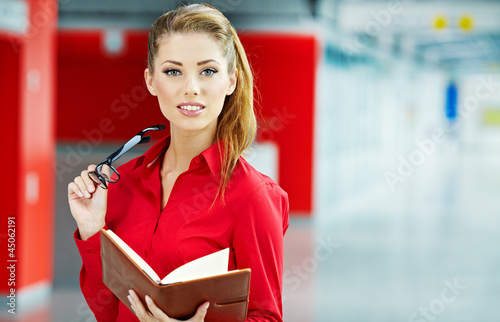 Photo: business woman holding glasses and looking at camera. Copy space business woman holding glasses and looking at camera. Copy space