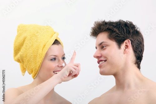Photo: young woman and young man with lotion young woman and young man with lotion