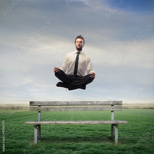 Photo: Businessman Levitating on a Bench Businessman Levitating on a Bench