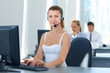 Photo: Female customer support operator with headset and smiling Female customer support operator with headset and smiling