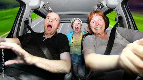 Photo: Funny family riding in a car. Funny family riding in a car.