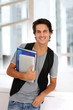 Cheerful college student standing in hall