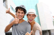 Happy friends showing thumbs up