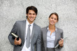 Cheerful business people standing on grey background