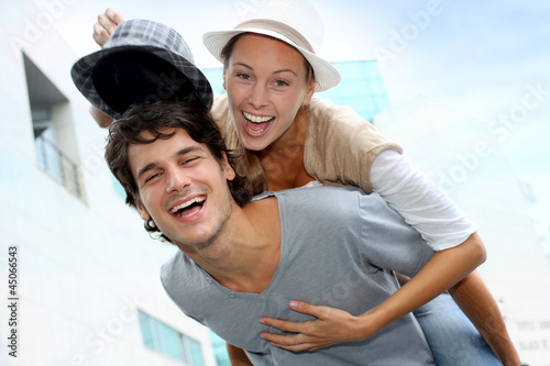 Photo: Man giving piggyback ride to girlfriend Man giving piggyback ride to girlfriend