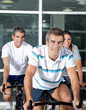 People On Spinning Bike In Health Club