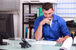 Manual worker at an office desk