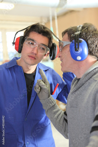 Photo: Men talking in a factory Men talking in a factory