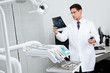 Photo: Dentist Analyzing X-Ray Report Dentist Analyzing X-Ray Report