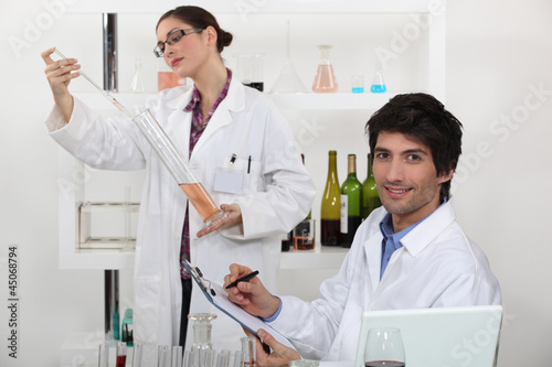 Photo: Oenologists analysing different wines Oenologists analysing different wines